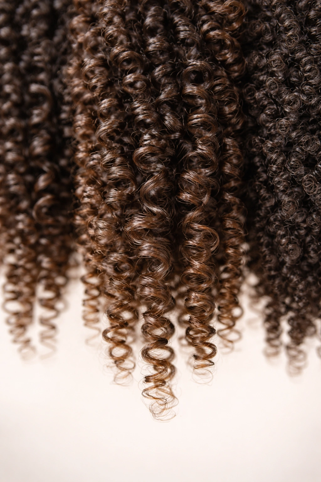 Macro close-up of 4A hair curl pattern showing S-curves