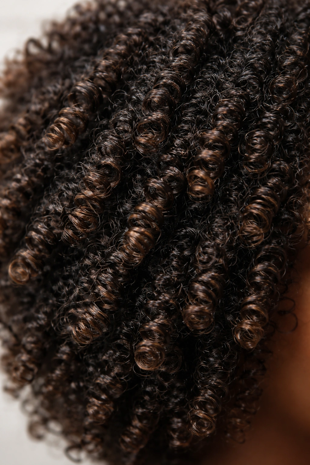 Close-up of 4A hair coils with S-shaped curls and volume