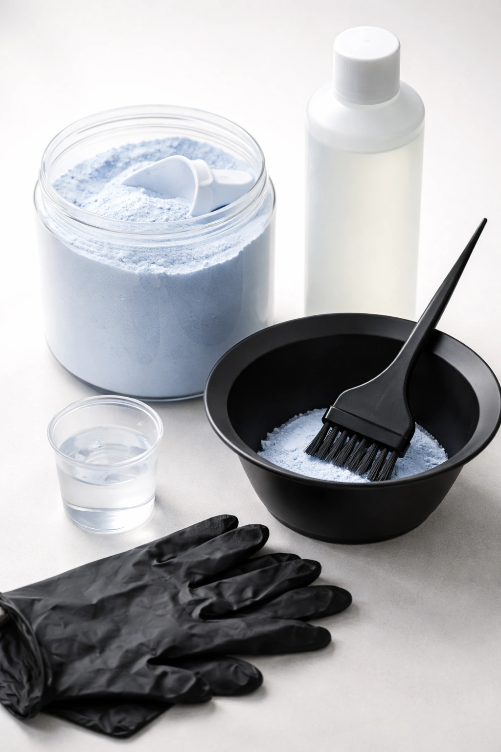 Unlabeled hair bleaching kit components arranged on a clean surface