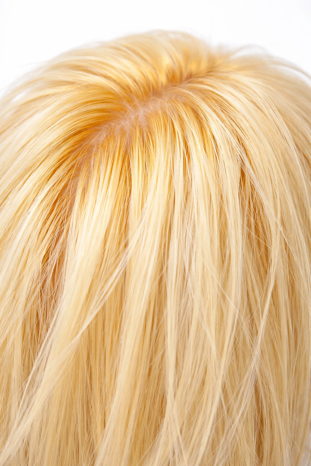Hair strand with yellow-orange undertones after bleaching