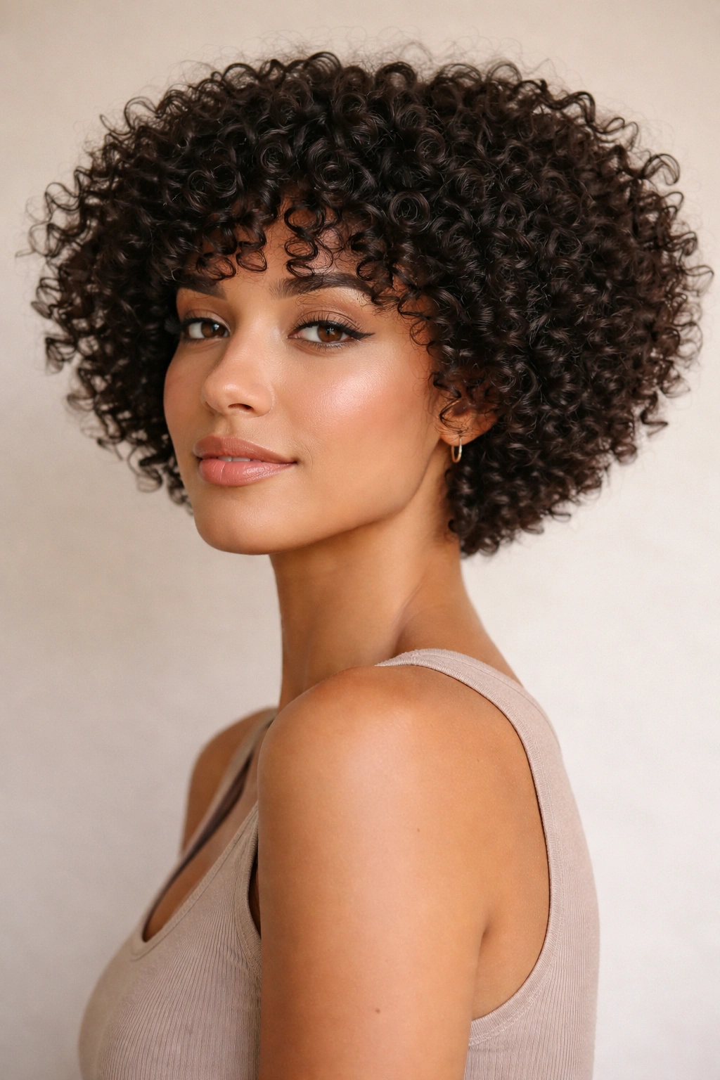 20 Short Curly Haircuts That Look Incredible 5 Blunt tapered curly cut with clustered curls for fullness.
