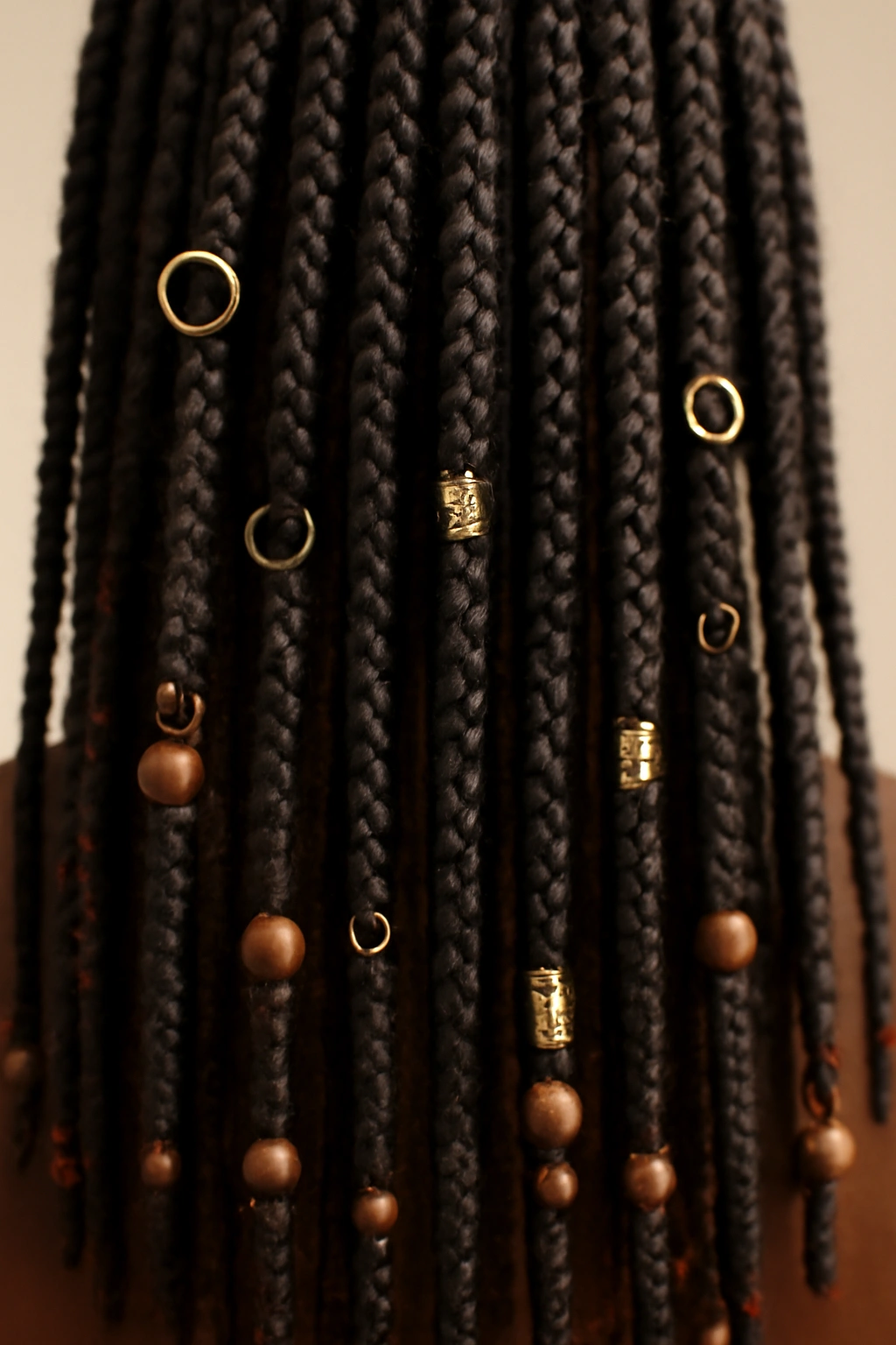 Box braids with beads and decorative elements along the length