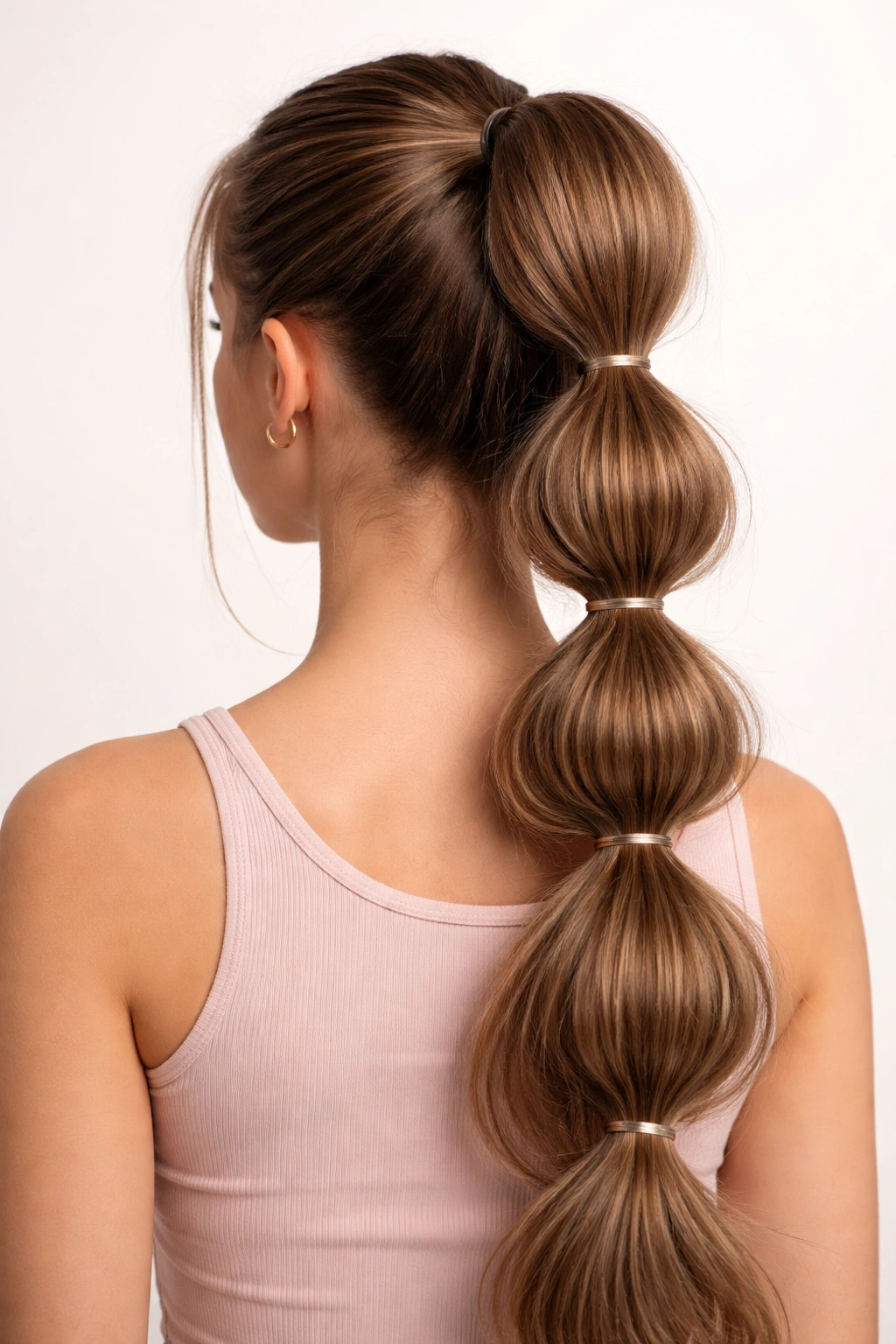 High ponytail with bubble sections created by elastics along its length
