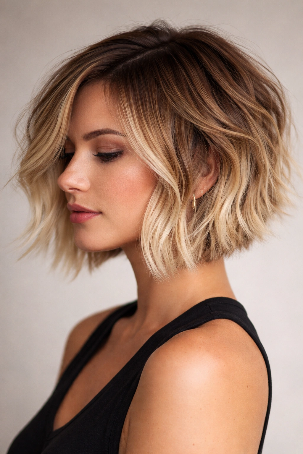Close-up of a choppy textured bob with caramel-to-blonde fade showing layered texture