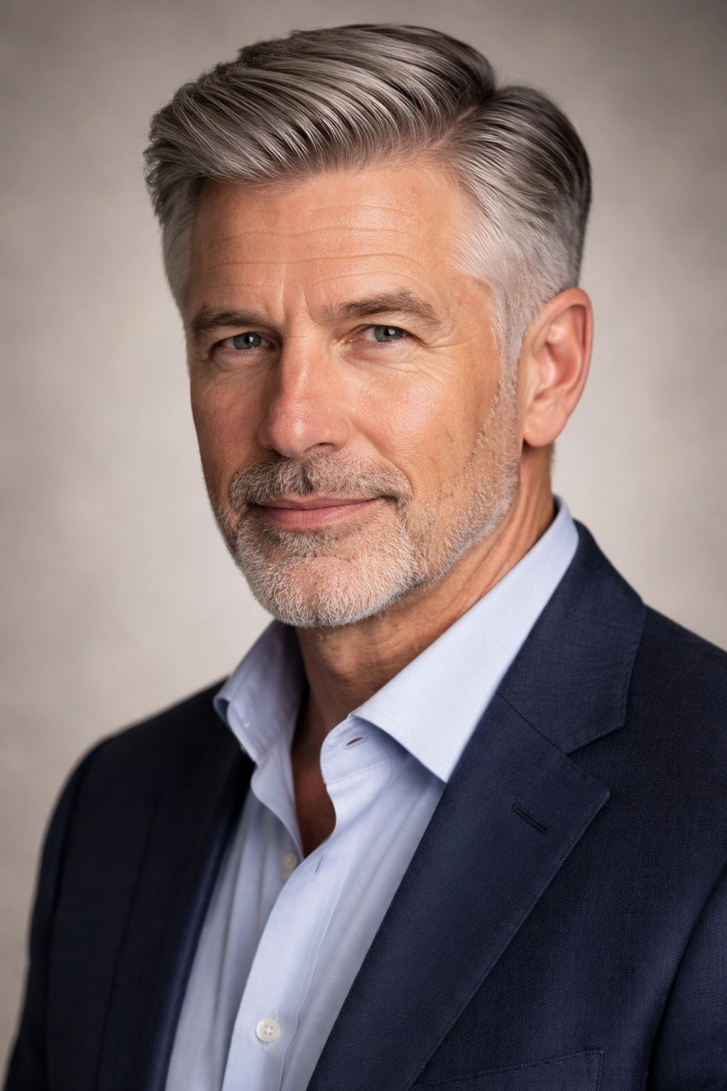 Portrait of a man with a classic side part and 2-3 inch top.
