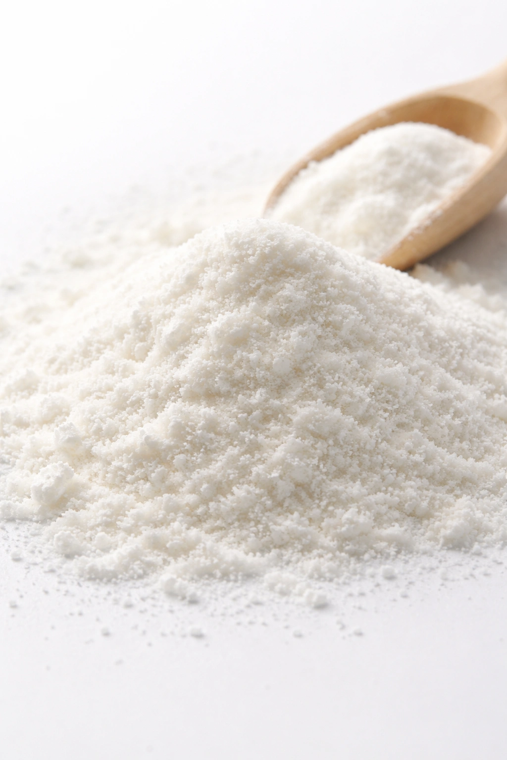Close-up of fine collagen powder on white surface