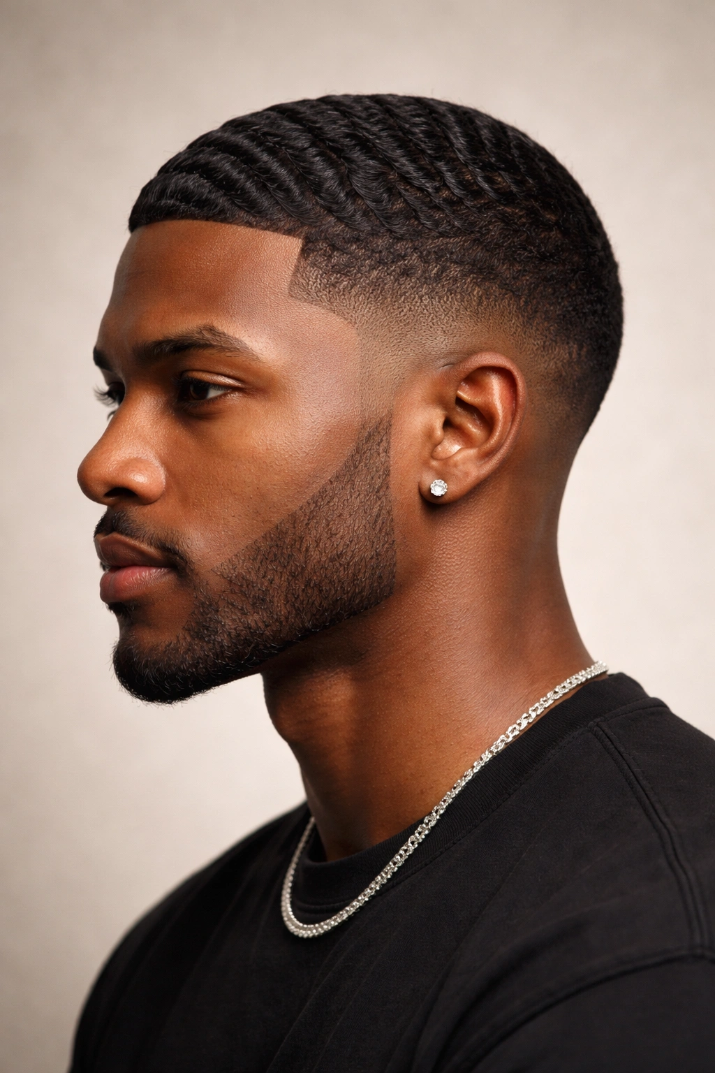 Black man with drop fade curving behind ears and textured top