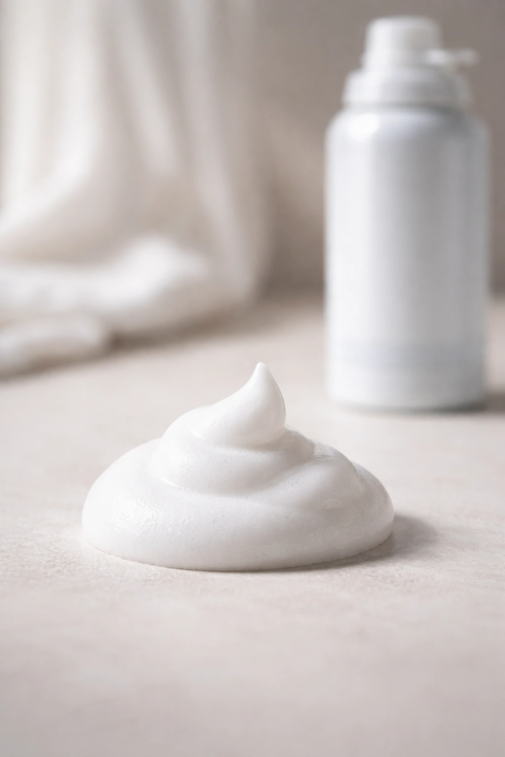 Small mousse foam puff on clean surface for dry-hair touch-ups
