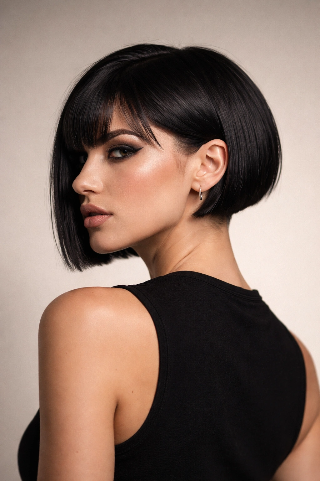 Portrait of a woman with an edgy short haircut in a minimalist studio, emphasizing hairstyle silhouette