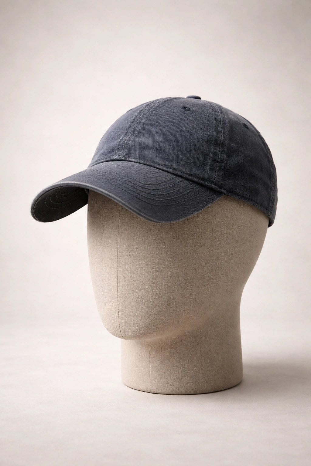 Hat on a plain head form in studio lighting.