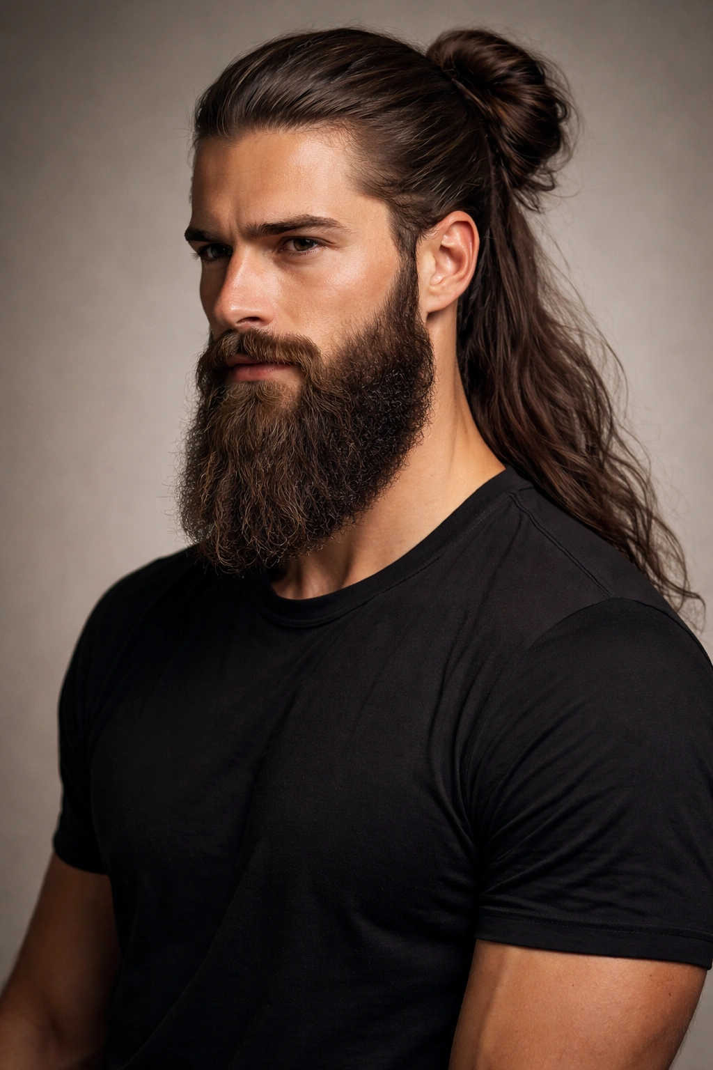 Portrait of a man with a bun and epic beard, studio lighting