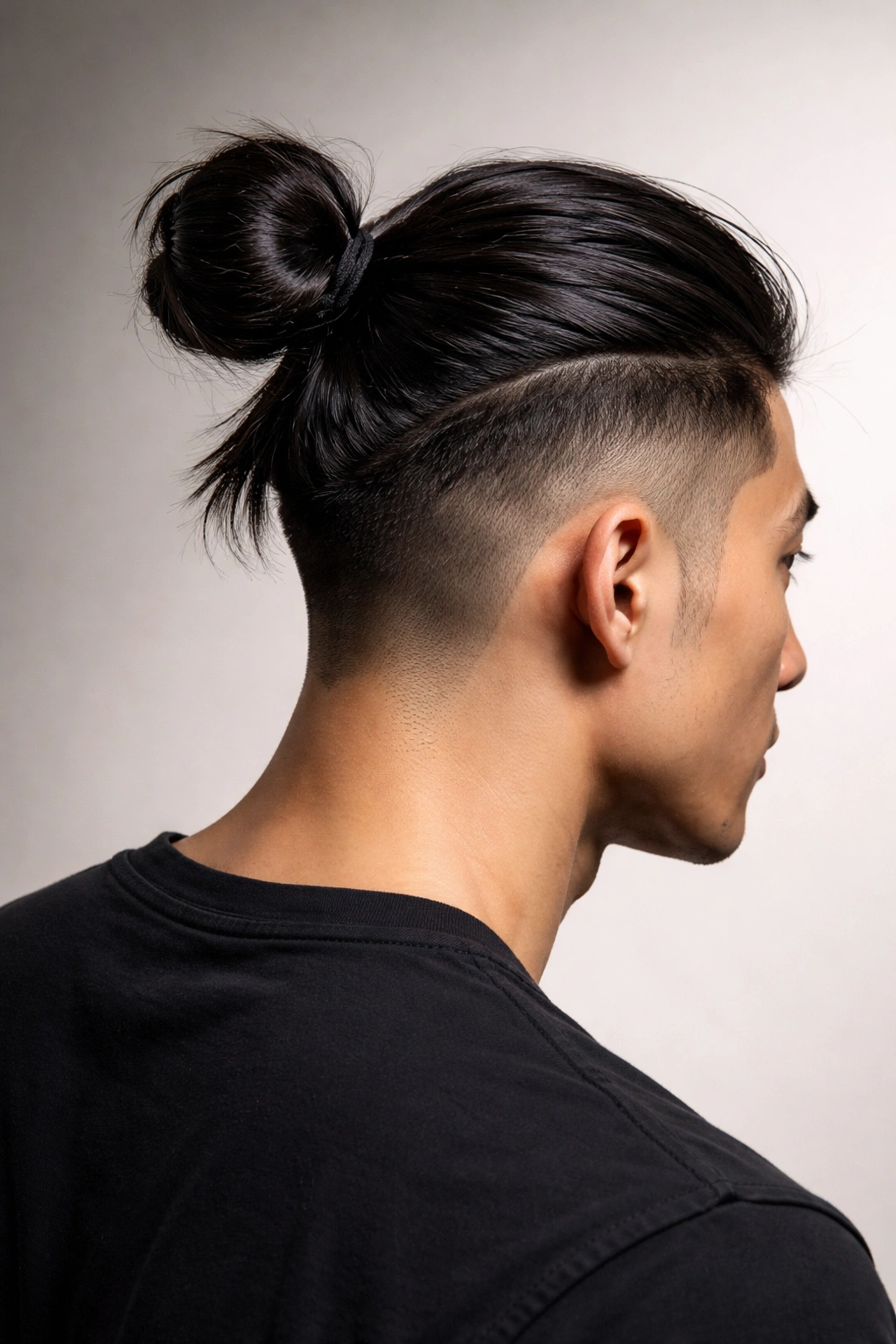 Back/side view of a man bun with an undercut and long top tied in a bun