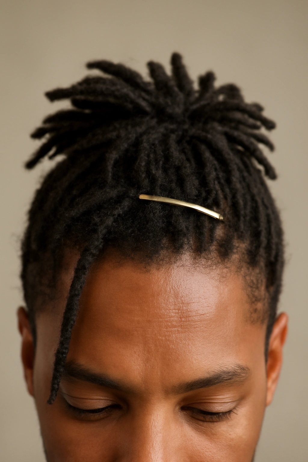10 Hairstyles to Try If You Have Short Dreads 9 Short dreadlocks styled with a minimalist clip shaping the crown for a polished look.