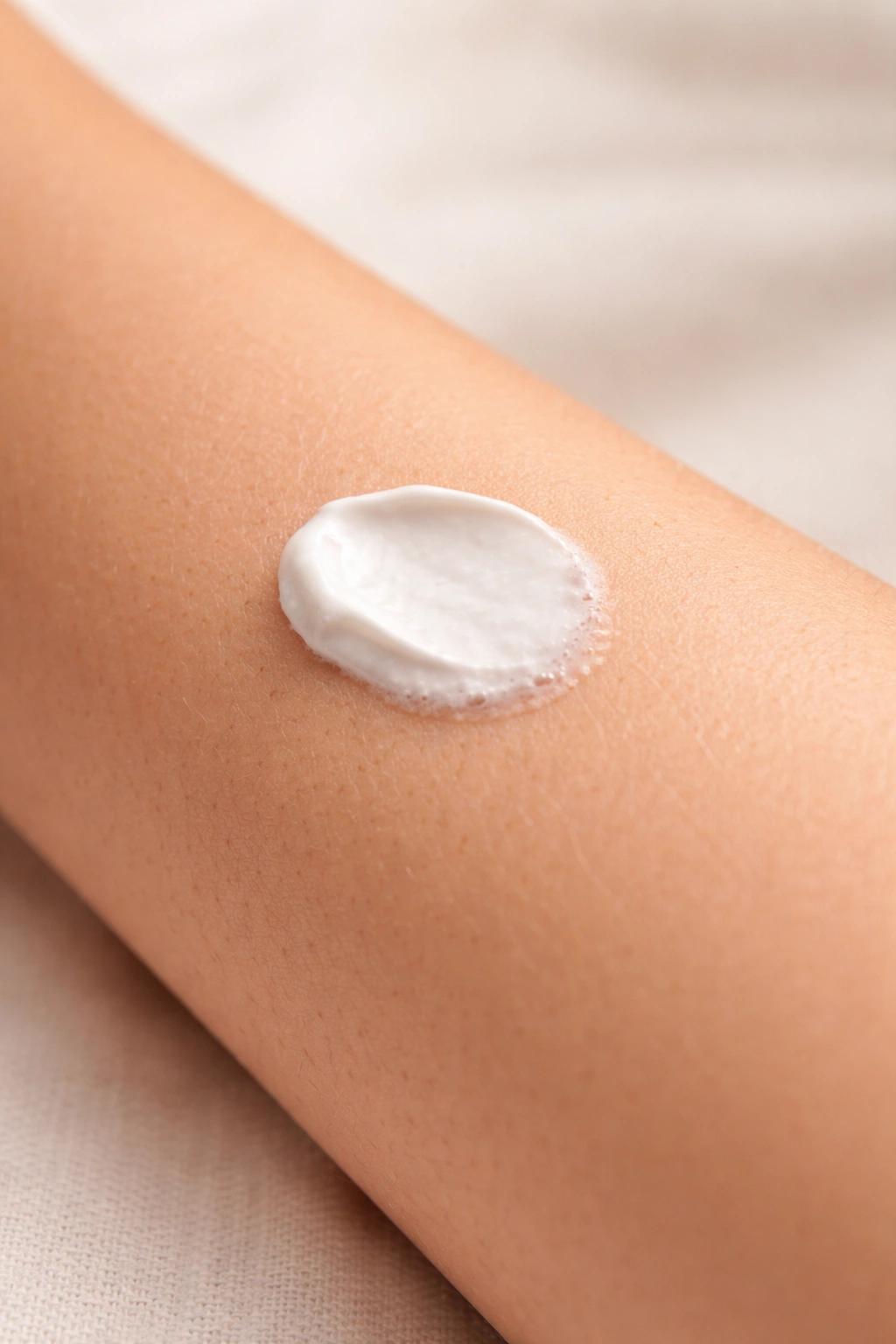Close-up of forearm showing patch test area with cream applied, skin texture visible