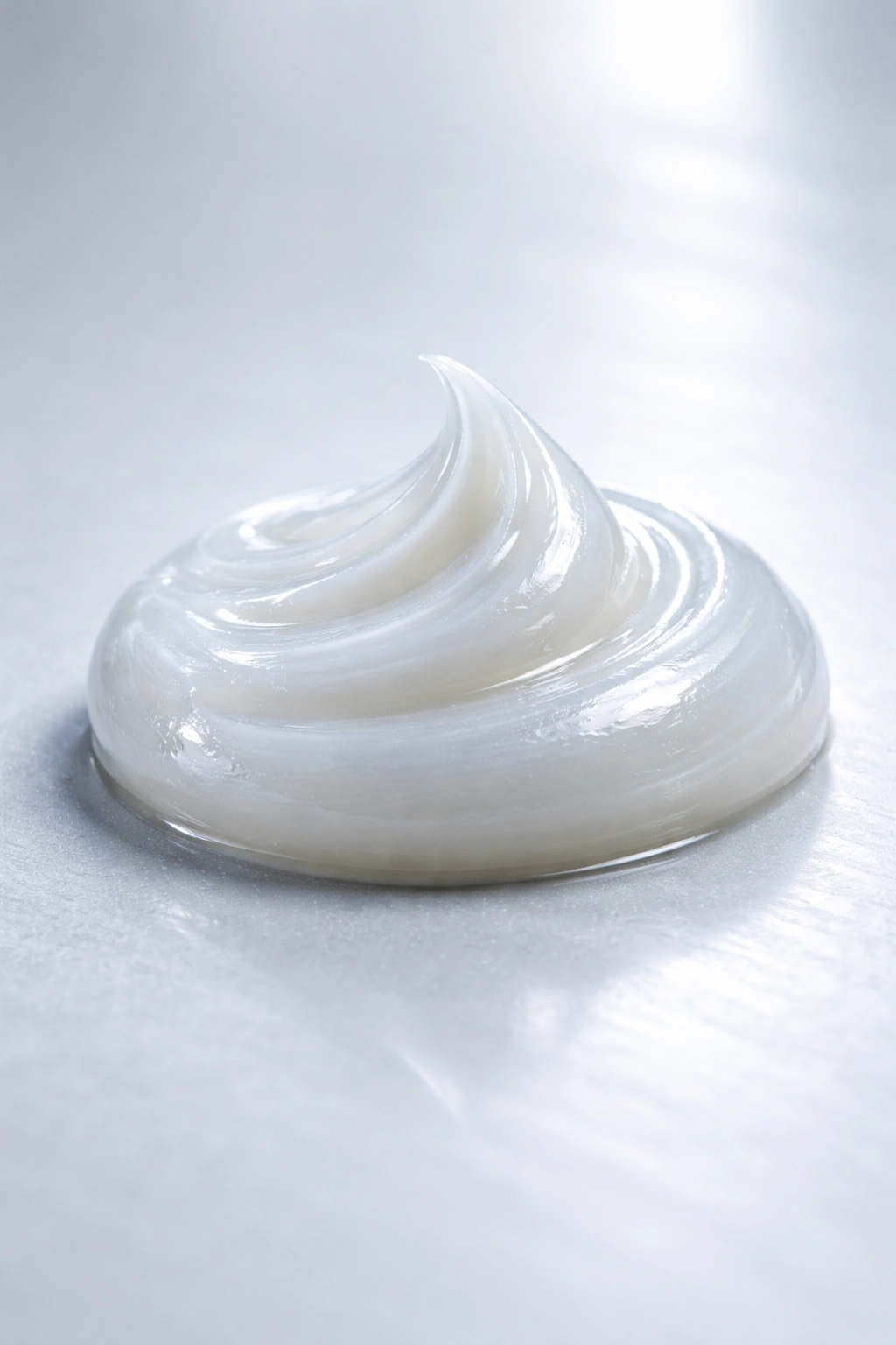 Small bead of pomade on smooth surface under clinical lighting