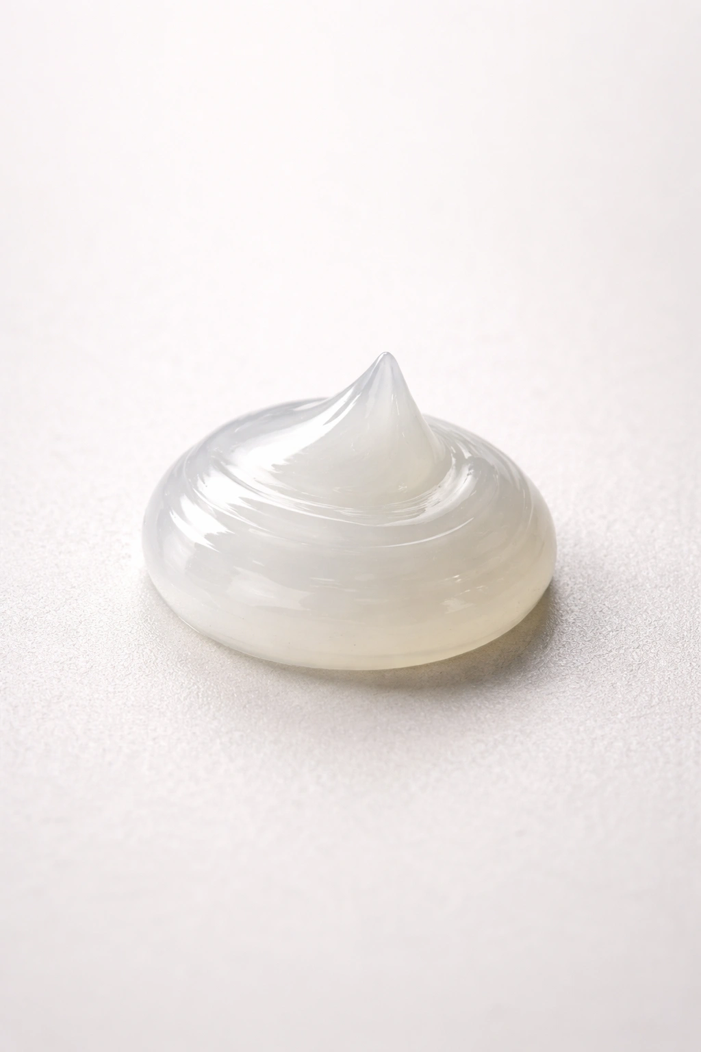 Pea-sized bead of pomade on a clean surface demonstrating moderate amount