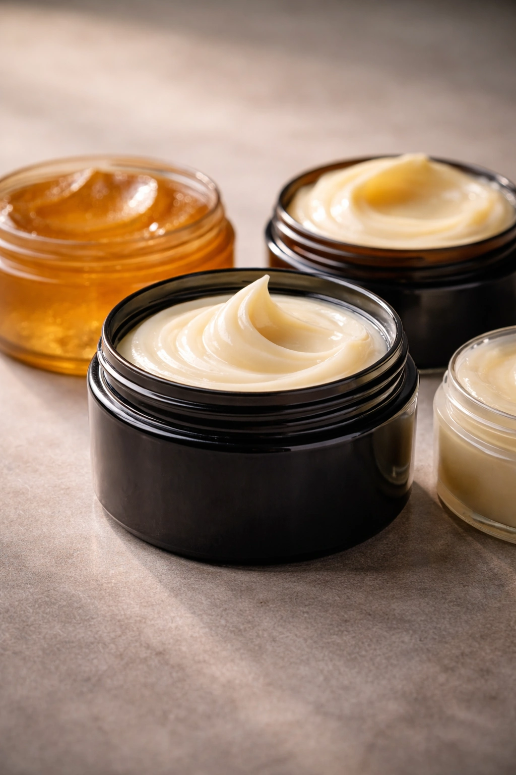 Close-up of a single jar of pomade on a neutral surface.