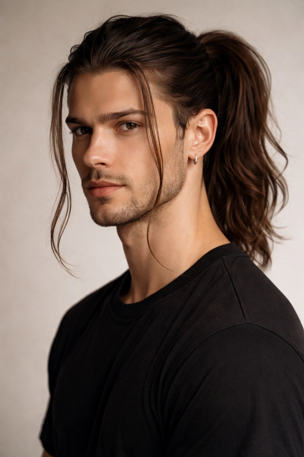Man with ponytail and two face-framing strands near temples