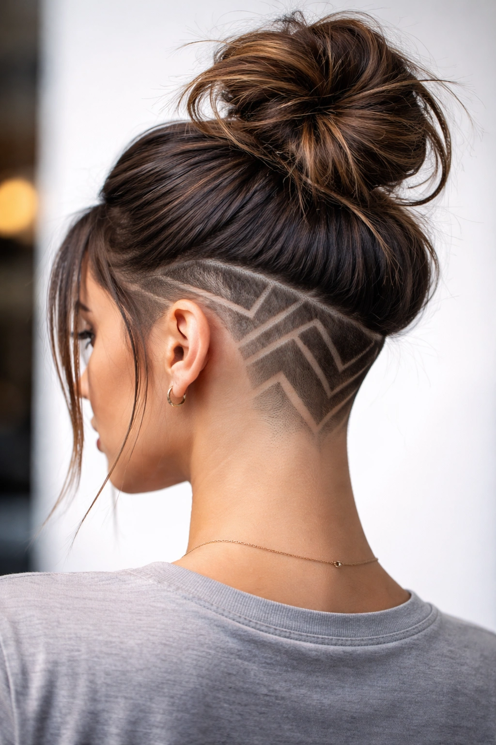 Portrait revealing shaved geometric designs under undercut with longer top hair.