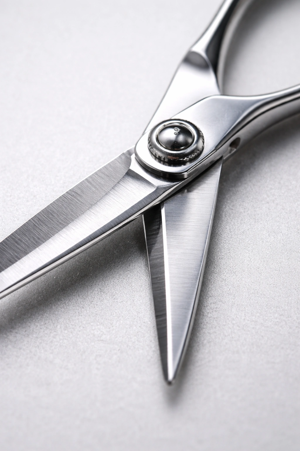 Close-up of misaligned hair scissors blades near the pivot screw