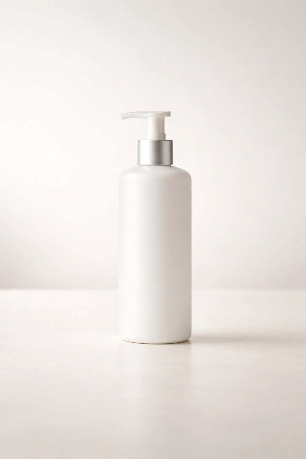 Minimalist shot of a plain shampoo bottle with pump on a clean surface
