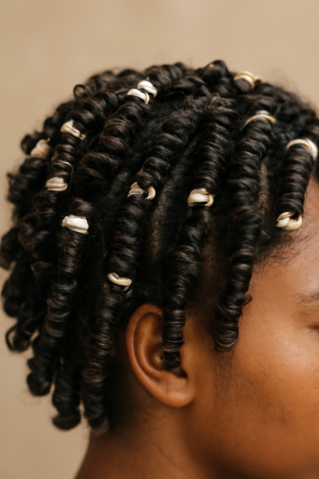 12 Short Curly Natural Hairstyles for Black Women 8 Close-up of short curls formed with perm rods to create defined spirals.