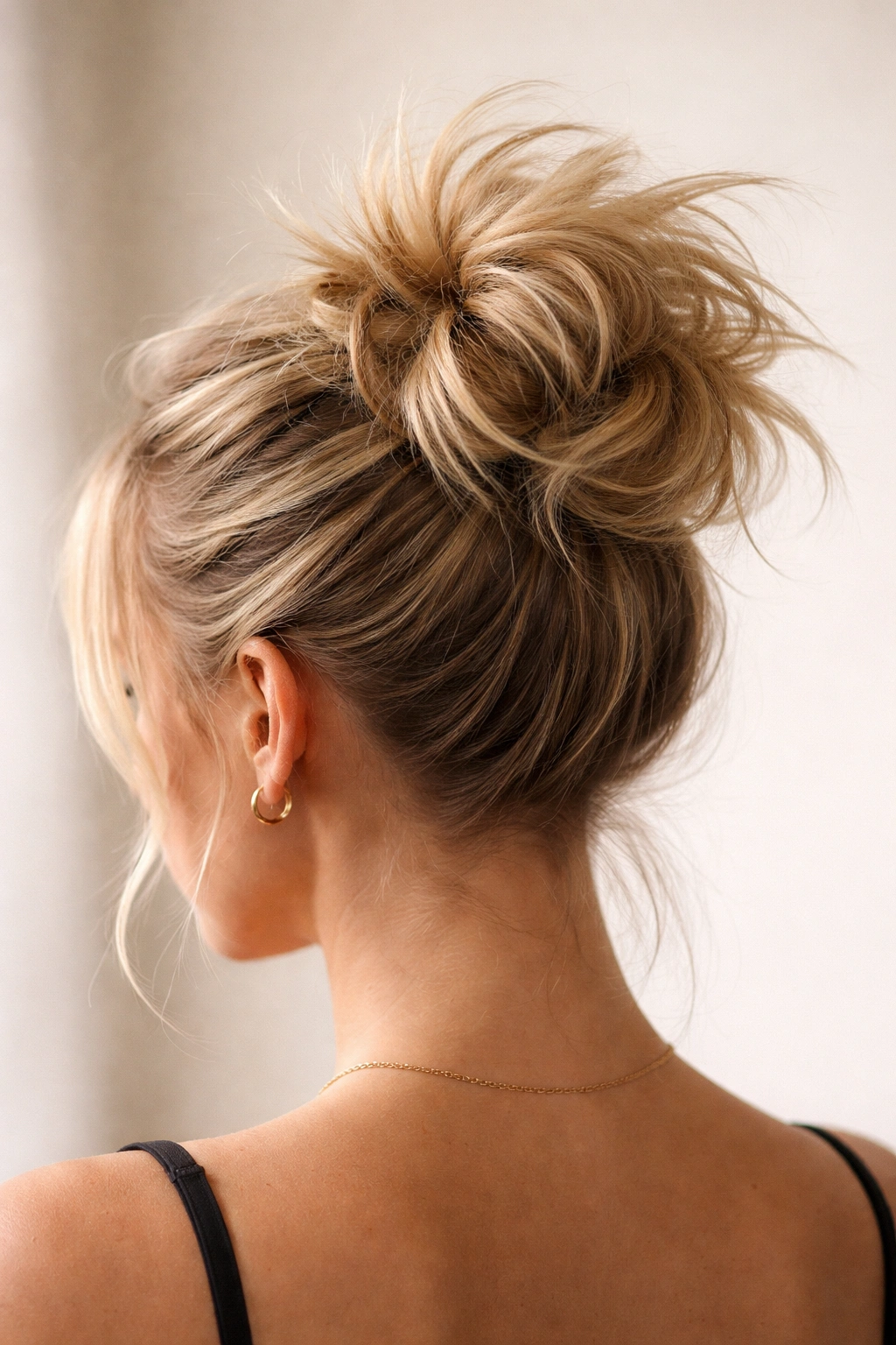 15 Easy Updos That Actually Work On Short Hair 15 Crown bun with teased volume and visible spikes around the bun on short hair