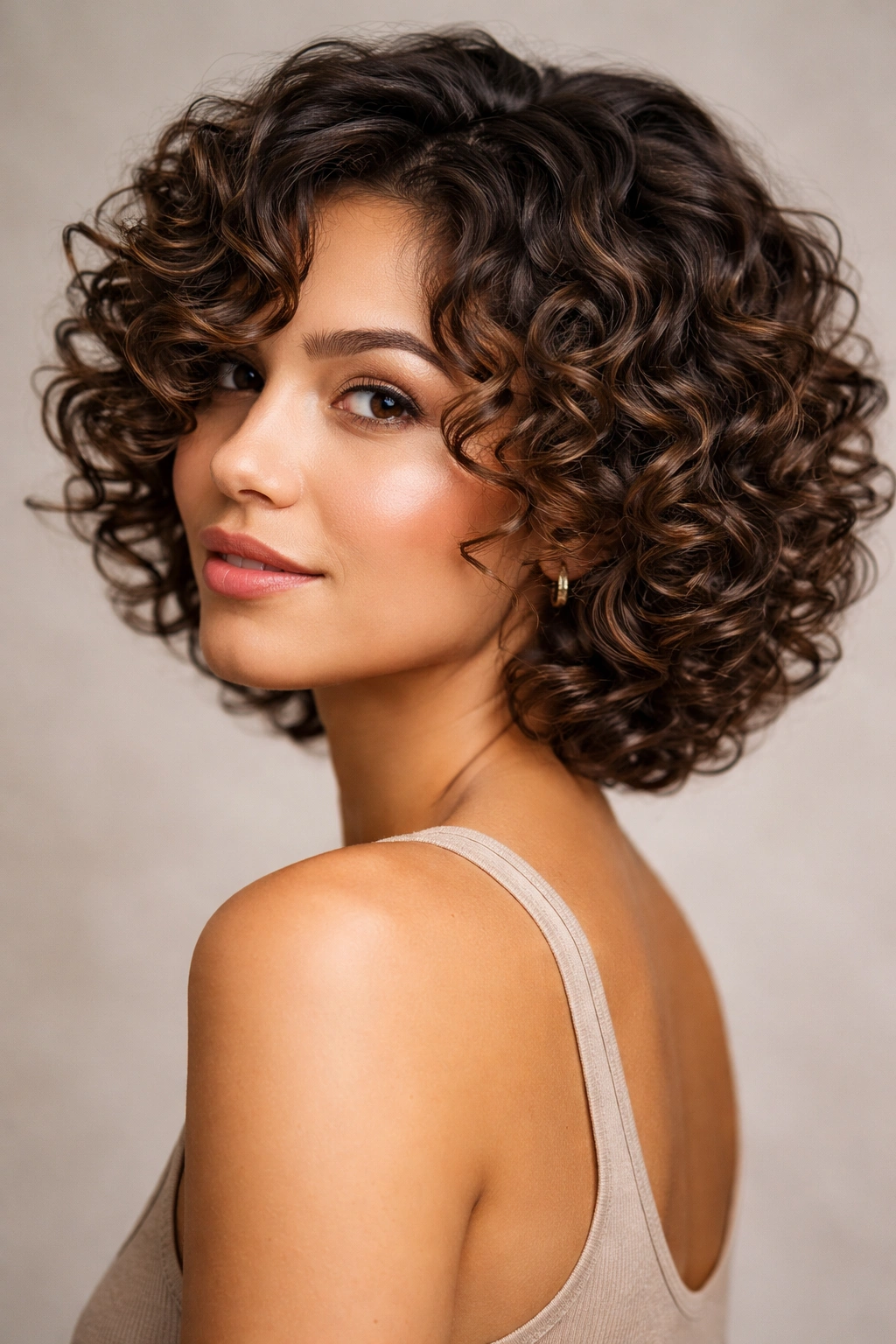 Portrait of defined spiral curls with layered cut enhancing curl shape.