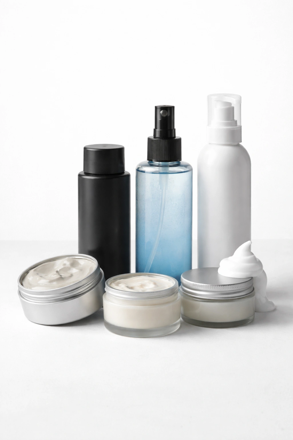 Unlabeled styling product containers on a clean surface