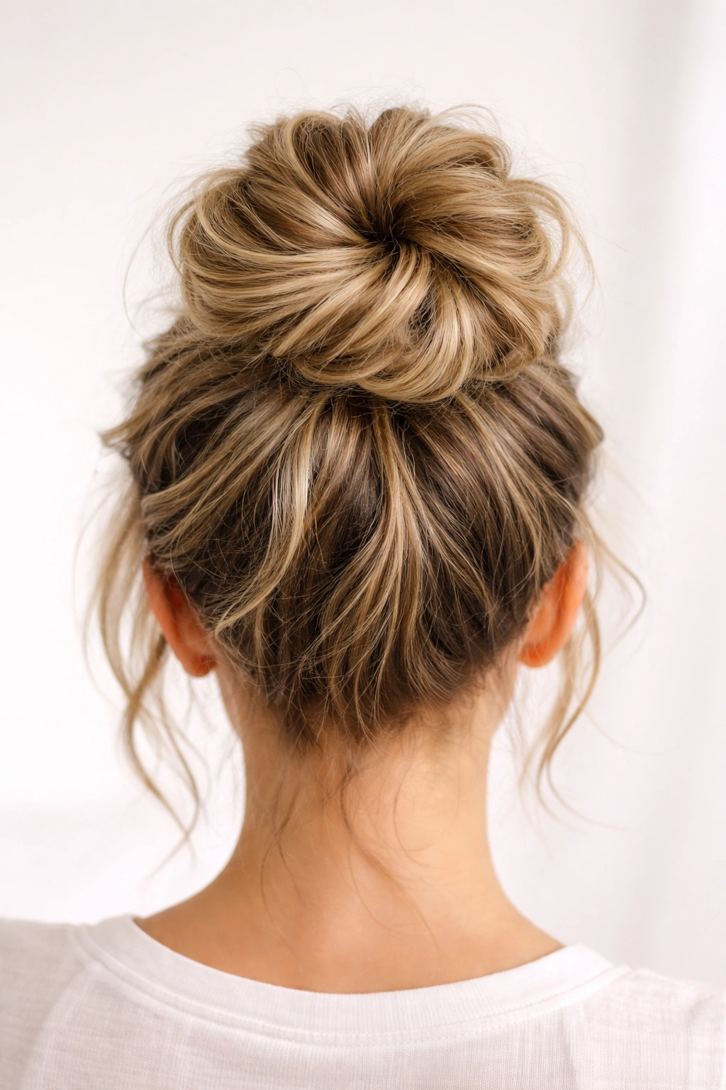 High crown bun with pre-textured waves on short hair