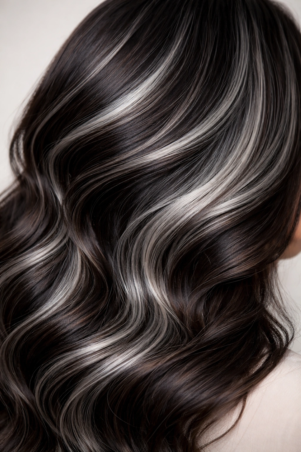 Salt-and-pepper hair with silver greys and dark brown tones