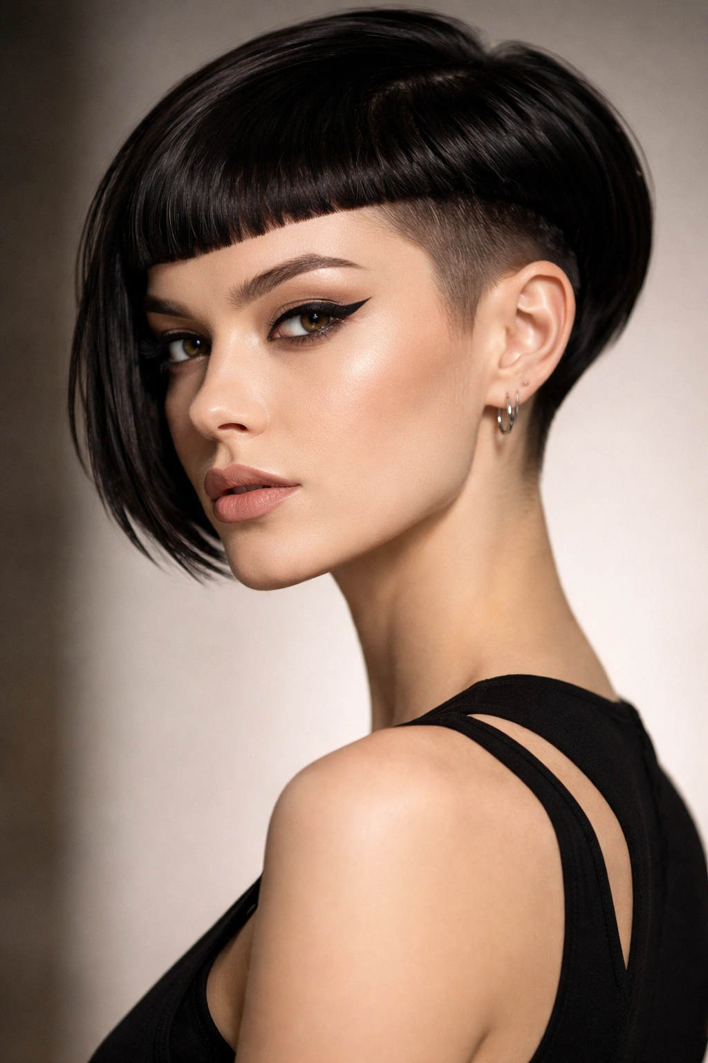 Portrait of a person with an architectural undercut bob and micro bangs