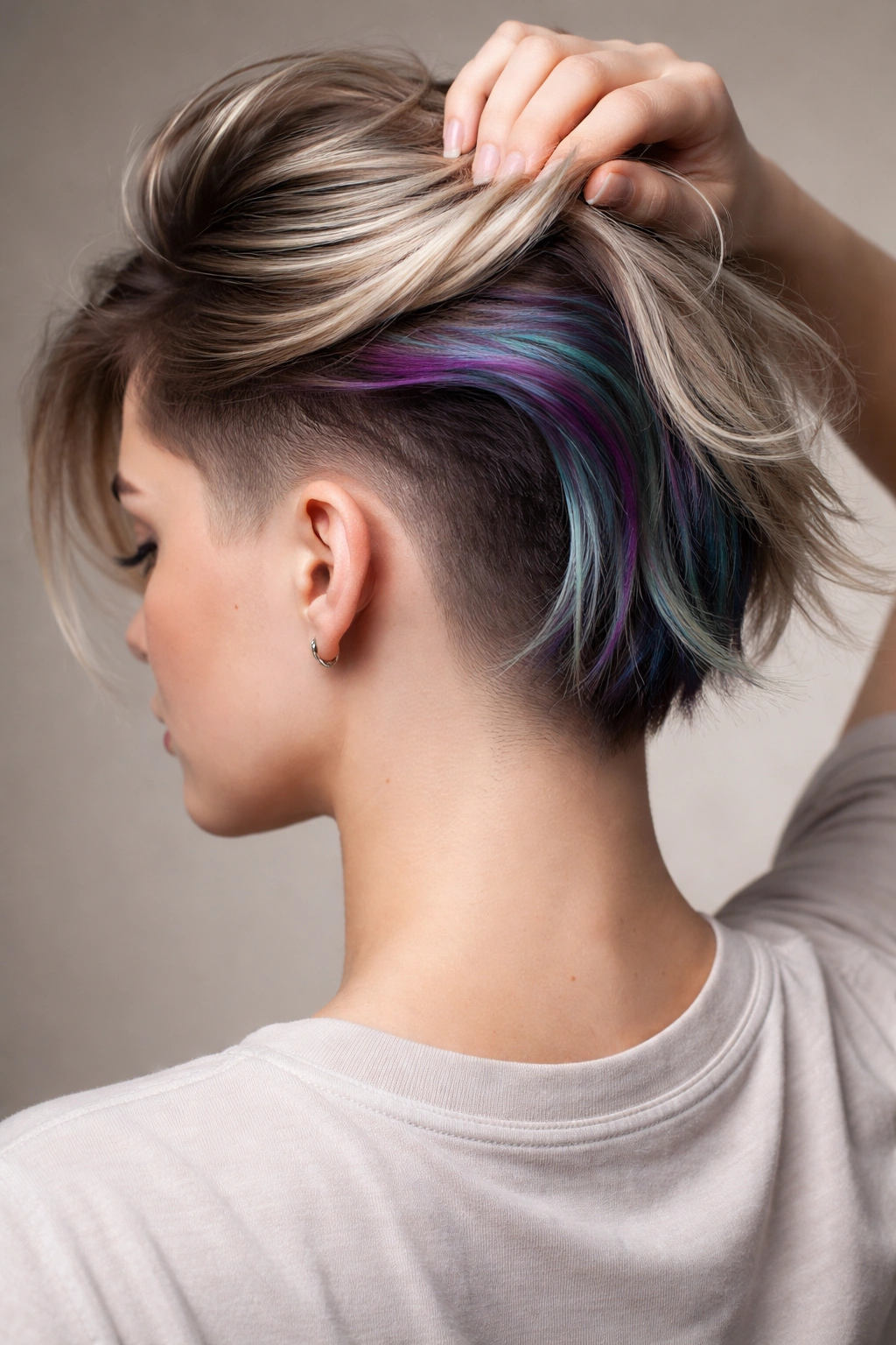 Close-up of a faded undercut with hidden color peeking when hair is lifted.