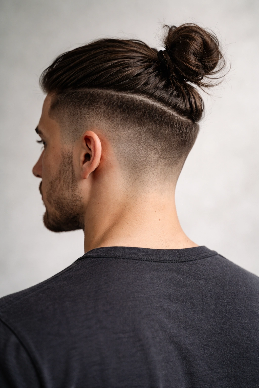 Undercut hairstyle with top knot visible from back view