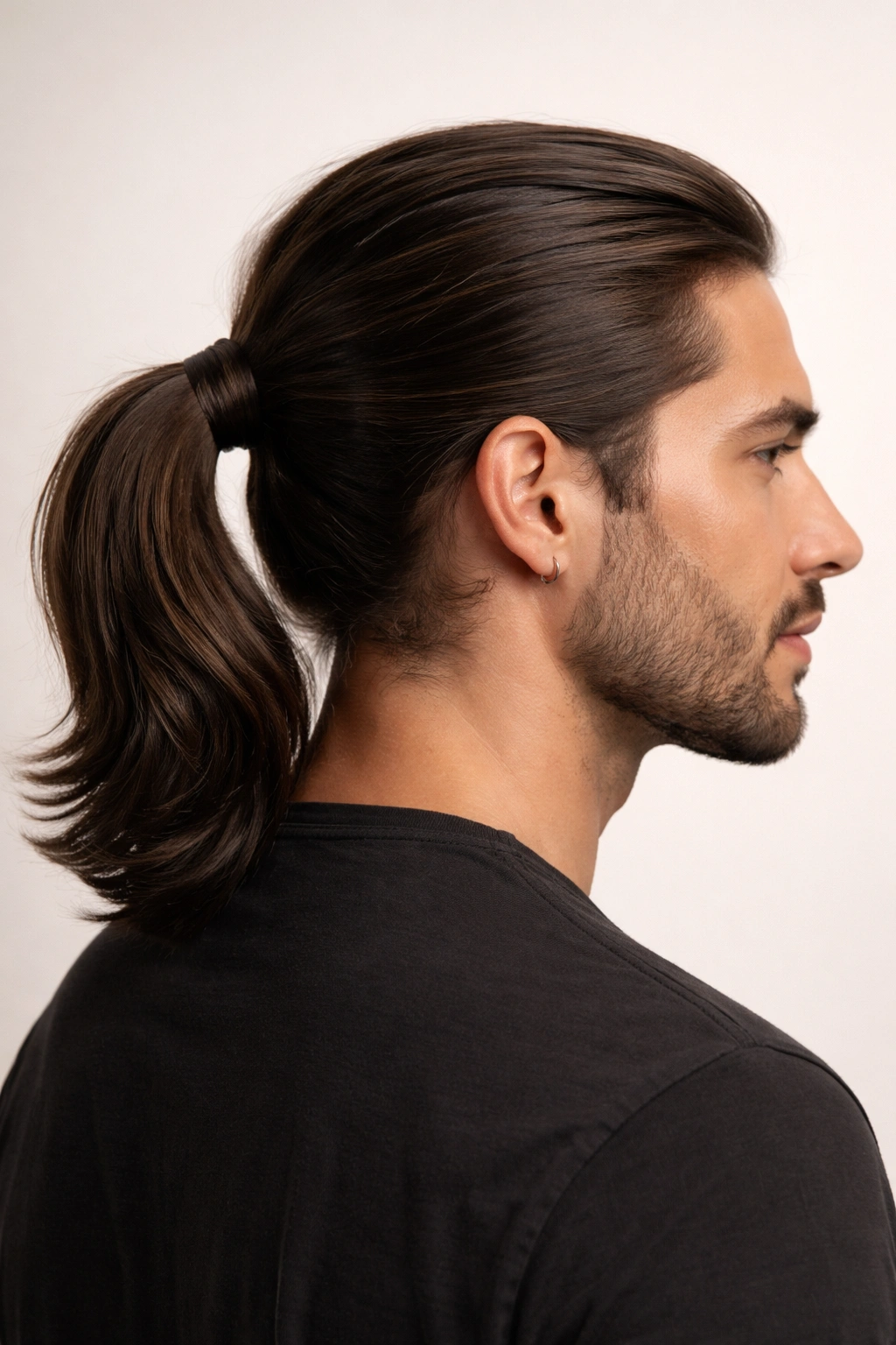 Close-up profile of a man with a wrapped ponytail showing a hair wrap concealing the elastic