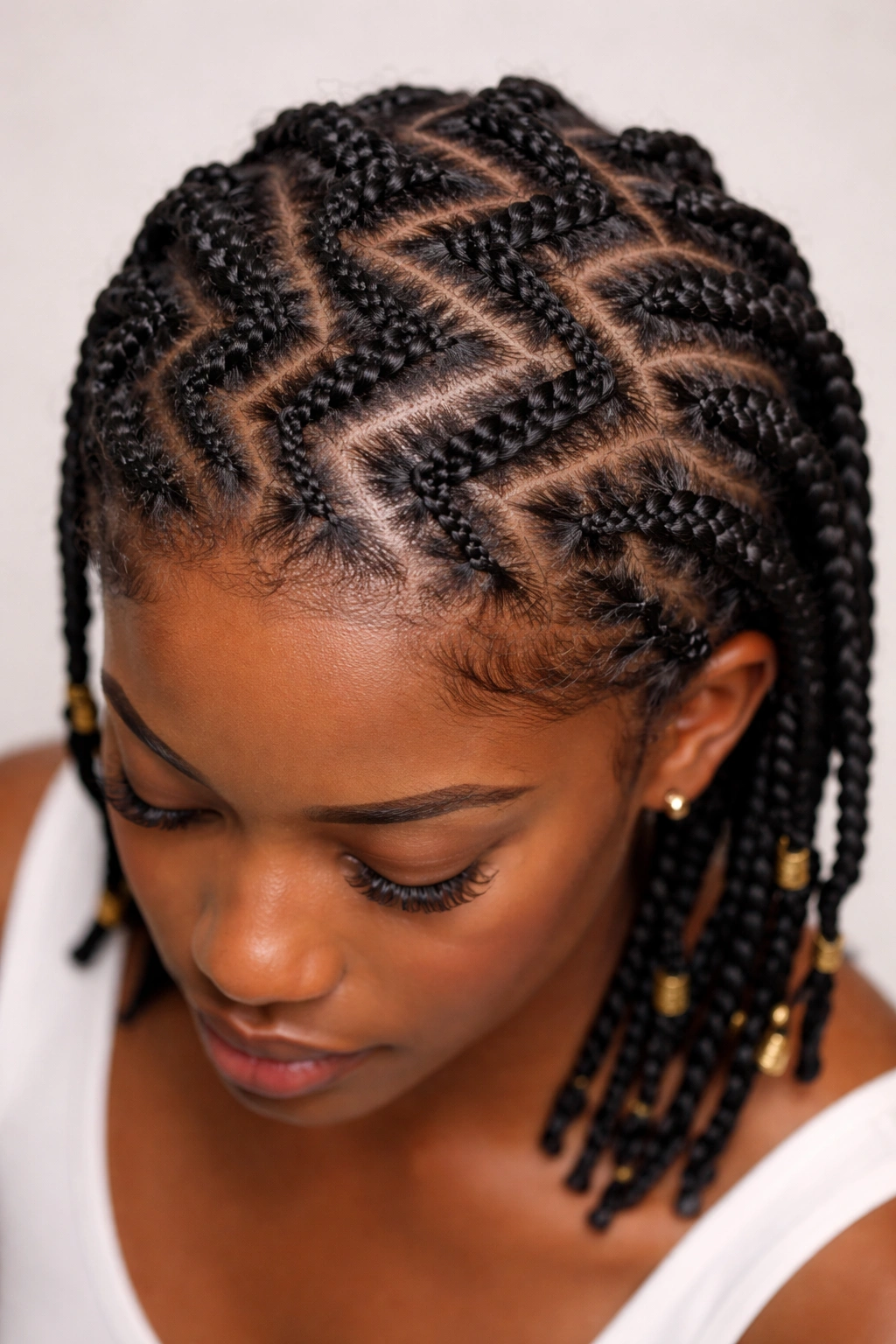 Close-up of zigzag parting on protective braids with textured natural hair